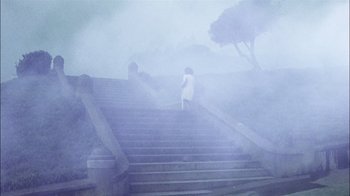 Movie still from “The Conversation” (1974), directed by Francis Ford Coppola – Two people walking down a set of stairs in the fog; Extreme Wide shot, High angle