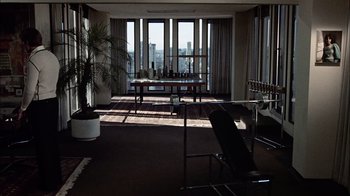 Movie still from “The Conversation” (1974), directed by Francis Ford Coppola – A room filled with lots of furniture and large windows; Extreme Wide shot, High angle