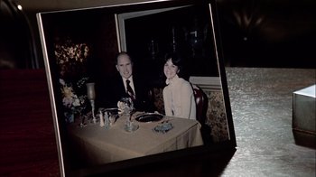 Movie still from “The Conversation” (1974), directed by Francis Ford Coppola – An older man and woman sitting at a dinner table; Extreme Close Up shot, High angle