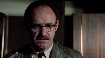 Movie still from “The Conversation” (1974), directed by Francis Ford Coppola – An older man wearing a suit and tie; Close Up shot, Low angle