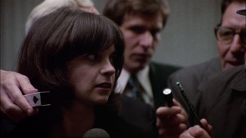 Movie still from “The Conversation” (1974), directed by Francis Ford Coppola – A man and a woman are talking to a microphone; Close Up shot, Over the shoulder angle