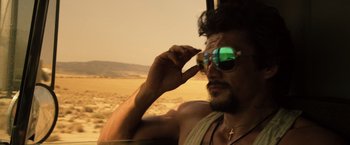Movie still from “The Counselor” (2013), directed by Ridley Scott – A person wearing sunglasses; Close Up shot, Over the shoulder angle
