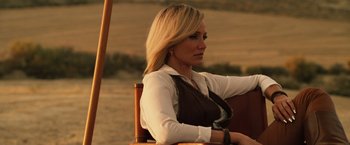 Movie still from “The Counselor” (2013), directed by Ridley Scott – A woman sitting on a chair in a field; Close Up shot, Over the shoulder angle