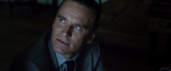 Movie still from “The Counselor” (2013), directed by Ridley Scott – A person wearing a suit and tie; Close Up shot, Low angle