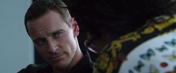Movie still from “The Counselor” (2013), directed by Ridley Scott – A person wearing a black shirt; Close Up shot, Over the shoulder angle