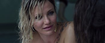 Movie still from “The Counselor” (2013), directed by Ridley Scott – A person with tattoos on their chest; Close Up shot, Over the shoulder angle