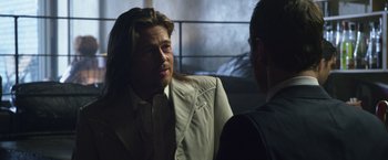 Movie still from “The Counselor” (2013), directed by Ridley Scott – A man with long hair talking to another man; Close Up shot, Over the shoulder angle