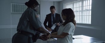 Movie still from “The Counselor” (2013), directed by Ridley Scott – A man and a woman holding hands while another man holds a handcuffed hand; Medium shot, Over the shoulder angle