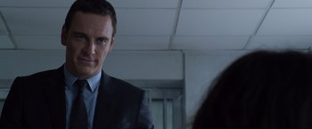 Movie still from “The Counselor” (2013), directed by Ridley Scott – A man in a suit and tie looking at a woman in a suit; Close Up shot, Over the shoulder angle