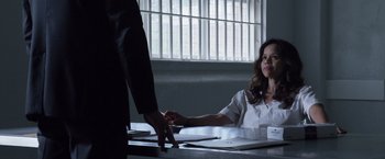 Movie still from “The Counselor” (2013), directed by Ridley Scott – A woman sitting at a table with a man in front of her; Medium shot, Over the shoulder angle