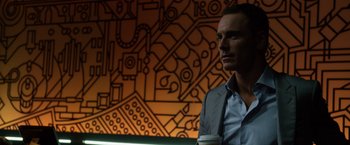 Movie still from “The Counselor” (2013), directed by Ridley Scott – A man in a suit and tie holding a coffee cup; Close Up shot, Low angle