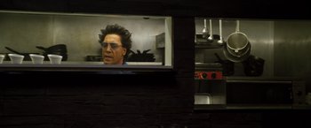Movie still from “The Counselor” (2013), directed by Ridley Scott – A man looking out of a window in a kitchen; Close Up shot, Low angle