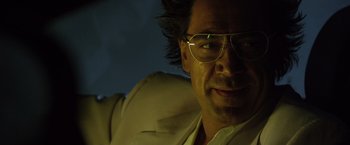 Movie still from “The Counselor” (2013), directed by Ridley Scott – A person wearing glasses and a suit jacket; Close Up shot, Low angle