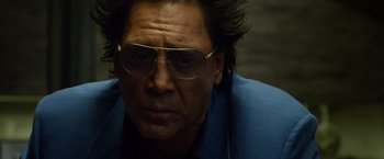 Movie still from “The Counselor” (2013), directed by Ridley Scott – A person wearing glasses; Close Up shot, Low angle