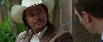 Movie still from “The Counselor” (2013), directed by Ridley Scott – A person wearing a cowboy hat; Close Up shot, Over the shoulder angle