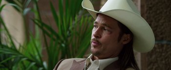 Movie still from “The Counselor” (2013), directed by Ridley Scott – A man wearing a white cowboy hat and a brown jacket; Close Up shot, Over the shoulder angle