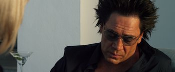 Movie still from “The Counselor” (2013), directed by Ridley Scott – A person wearing a black shirt and sunglasses; Close Up shot, Low angle