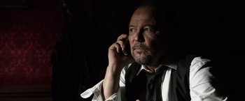 Movie still from “The Counselor” (2013), directed by Ridley Scott – A person talking on a cell phone; Close Up shot, Low angle