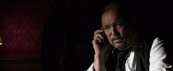 Movie still from “The Counselor” (2013), directed by Ridley Scott – A person talking on a cell phone; Close Up shot, Low angle