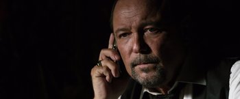 Movie still from “The Counselor” (2013), directed by Ridley Scott – A person talking on a cell phone; Close Up shot, Low angle