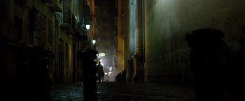 Movie still from “The Counselor” (2013), directed by Ridley Scott – People are walking down a street at night time; Extreme Wide shot, Low angle
