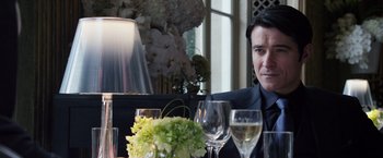 Movie still from “The Counselor” (2013), directed by Ridley Scott – A man sitting at a dinner table with wine glasses; Close Up shot, Over the shoulder angle