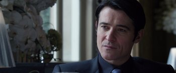 Movie still from “The Counselor” (2013), directed by Ridley Scott – A person wearing a suit and tie; Close Up shot, Over the shoulder angle