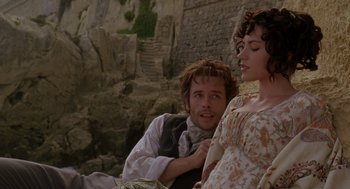 Movie still from “The Count of Monte Cristo” (2002), directed by Kevin Reynolds – A man and a woman sitting next to each other on a cliff; Medium shot, High angle