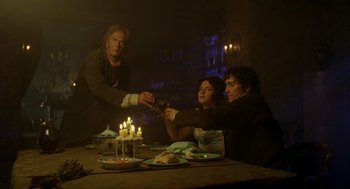 Movie still from “The Count of Monte Cristo” (2002), directed by Kevin Reynolds – Three people sitting at a dinner table with candles; Medium shot, Over the shoulder angle