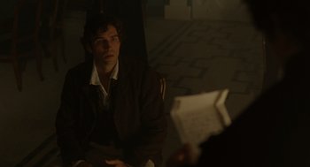 Movie still from “The Count of Monte Cristo” (2002), directed by Kevin Reynolds – A man sitting on the ground in a dark room; Medium shot, Over the shoulder angle