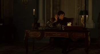 Movie still from “The Count of Monte Cristo” (2002), directed by Kevin Reynolds – A man sitting at a table in a dark room; Medium shot, High angle