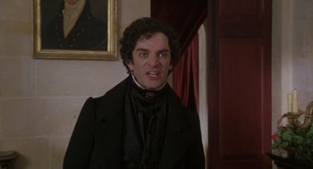Movie still from “The Count of Monte Cristo” (2002), directed by Kevin Reynolds – A man in a black jacket and a red tie; Close Up shot, Over the shoulder angle