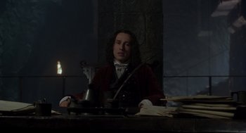 Movie still from “The Count of Monte Cristo” (2002), directed by Kevin Reynolds – A man sitting at a table in front of a candle; Medium shot, Low angle