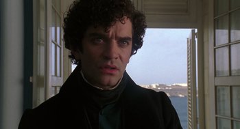 Movie still from “The Count of Monte Cristo” (2002), directed by Kevin Reynolds – A person with curly hair wearing a suit; Close Up shot, Over the shoulder angle