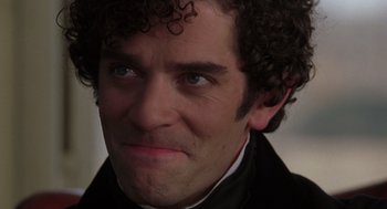 Movie still from “The Count of Monte Cristo” (2002), directed by Kevin Reynolds – A person with curly hair wearing a suit; Close Up shot, Over the shoulder angle