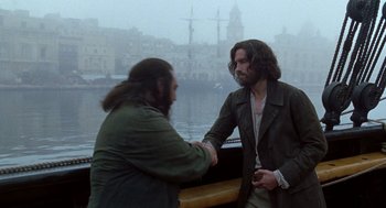 Movie still from “The Count of Monte Cristo” (2002), directed by Kevin Reynolds – Two men shaking hands on a boat in the water; Medium shot, Over the shoulder angle