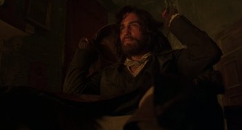 Movie still from “The Count of Monte Cristo” (2002), directed by Kevin Reynolds – A man with long hair and a goatee is listening to music; Medium shot, Low angle