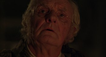 Movie still from “The Count of Monte Cristo” (2002), directed by Kevin Reynolds – An old man wearing glasses looking at the camera; Close Up shot, Low angle