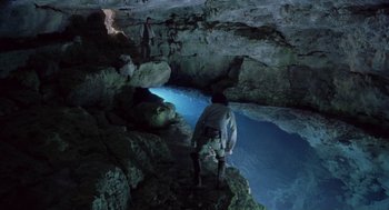 Movie still from “The Count of Monte Cristo” (2002), directed by Kevin Reynolds – Two people are standing in a cave looking into the water; Wide shot, High angle