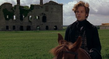 Movie still from “The Count of Monte Cristo” (2002), directed by Kevin Reynolds – A man standing next to a horse in a field; Medium shot, Over the shoulder angle