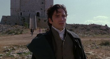 Movie still from “The Count of Monte Cristo” (2002), directed by Kevin Reynolds – A man standing in front of a stone building; Close Up shot, Over the shoulder angle