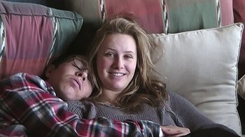 Movie still from “The Crash Reel” (2013), directed by Lucy Walker – A woman and a man laying in a bed; Close Up shot, Overhead angle