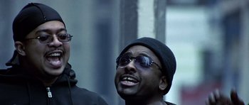 Movie still from “Phone Booth” (2002), directed by Joel Schumacher – A person wearing sunglasses and a hat; Close Up shot, Low angle