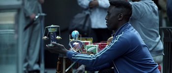 Movie still from “Phone Booth” (2002), directed by Joel Schumacher – A man sitting in front of a table holding a phone; Medium shot, Low angle