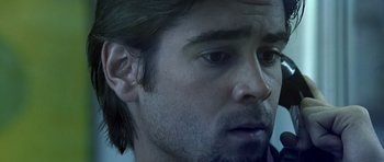 Movie still from “Phone Booth” (2002), directed by Joel Schumacher – A man's face in a dark room; Close Up shot, Low angle