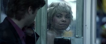 Movie still from “Phone Booth” (2002), directed by Joel Schumacher – A woman looking out of a window on a train; Close Up shot, Over the shoulder angle