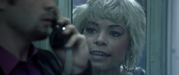 Movie still from “Phone Booth” (2002), directed by Joel Schumacher – A person taking a picture in a mirror; Close Up shot, Over the shoulder angle