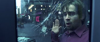 Movie still from “Phone Booth” (2002), directed by Joel Schumacher – A man looking through a broken window at night; Close Up shot, Over the shoulder angle