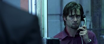Movie still from “Phone Booth” (2002), directed by Joel Schumacher – A person wearing a red shirt; Close Up shot, Over the shoulder angle