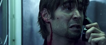 Movie still from “Phone Booth” (2002), directed by Joel Schumacher – A person's ear with blood on it; Close Up shot, Low angle